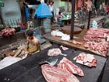 Butchery  Open air shop.  Sarongs are the typical clothing.