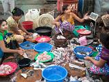 Women preparing fish  A stall at the major fish market along the Yangon River.