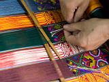 Weaving detail  The main warp threads are passed with a shuttle, but the intricate patterns are hand woven.