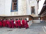 Student monks at a dzong  Dzongs are fortified monasteries.  Here, the seated monks are defending Buddha'a teachings.  The standing ones are trying to refute them.  It's similar to the Jewish pilpul.
