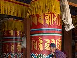 Man turning prayer wheel at temple
