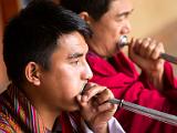 Musicians blowing long horns