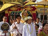 Initiate surrounded by family  Before and behind the boy is a procession of extended family and freinds.