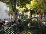 Canal and sidewalk cafe  Goudargue, France